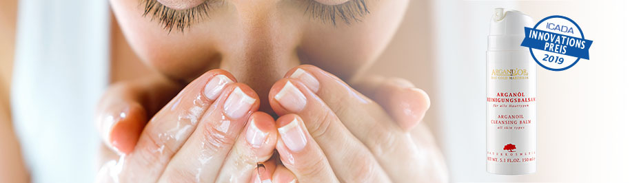 Frau während dem Gesicht reinigen mit Wasser und Arganöl Reinigungsbalsam für alle Hauttypen